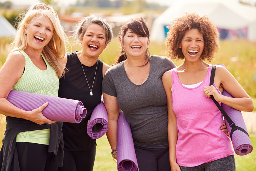 Mature Female Friends with Yoga Mats